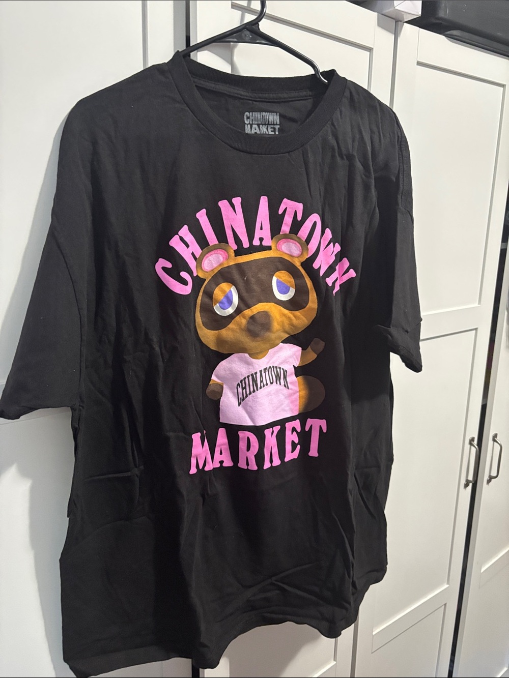 Chinatown Market Black T-Shirt with Pink Cartoon Graphic